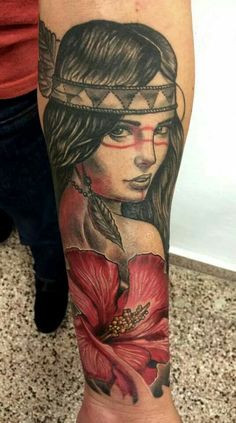 a woman's arm with a tattoo on it and a flower in the middle