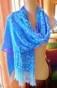 This is a big, beautiful cut velvet scarf with fringe. The colors are blue silk background with a very slight warm tone in some areas. The plush areas are silvery white. This warm and cozy silk blend scarf is luxurious and also light weight. Wrap in and wear it many ways. It's a wonderful, rich looking textile that will add to a Bohemian style or shabby chic style. Its hand dyed and one of a kind. The fringe is silky and a light blue color. So pretty! This makes a great gift! Blue Silk Background, Silk Background, Velvet Scarf, Scarf With Fringe, Blue Beauty, Warm Tone, Shabby Chic Style, Light Blue Color, Blue Silk