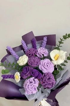 purple and white flowers are in a bouquet