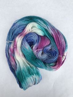 a skein of multicolored yarn sitting on top of a white surface