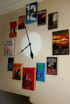 a clock made out of books on the wall