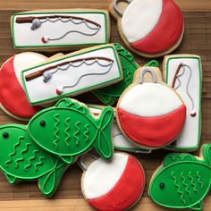 decorated cookies with fishing related items displayed on wooden table top, ready to be eaten