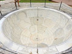 a circular concrete structure with writing on it