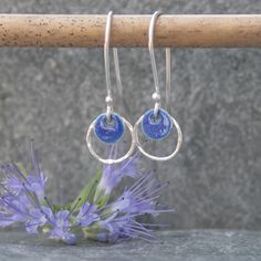 These hoop earrings were handmade from sterling silver and a navy blue enamelled silver disc.  I have hammered the silver hoop to give it added texture and a bit of sparkle. These silver earrings would be a lovely Mothers day gift or Valentines gift.  They are also available in a pale blue colour https://www.etsy.com/uk/listing/627277950/silver-and-enamel-earrings-sterling?ref=shop_home_active_1 although I can make them in the colour of your choice.  Please message me to arrange a different colour if required. You will receive these earrings gift wrapped. Click here to return to Thistledown Wishes home page https://www.etsy.com/uk/shop/ThistledownWishes?ref=seller-platform-mcnav. Click here to see more earrings https://www.etsy.com/uk/shop/ThistledownWishes?ref=seller-platform-mcnav§ion_id Blue Enamel Earrings, Silver Circle Earrings, Long Silver Earrings, Hoop Earrings Silver, Enamel Earrings, Delicate Earrings, Hammered Silver, Enamel Jewelry, Etsy Earrings Dangle