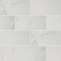 a white marble tile wall that looks like it has been polished