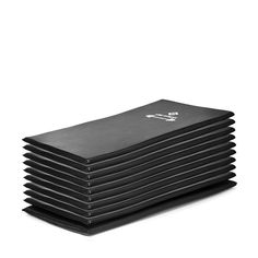 a stack of black napkins sitting on top of each other