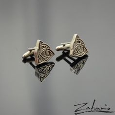 Cufflinks in shape of celtic knot, all details created under the magnifying glass. The Celtic knot symbolizes perfection and an unbreakable bond. Its curled shape signifies the winding paths of human life, and it's triple knots strengthen love and friendship. This symbol protects against falsehood, slander and enslavement. Dimensions: Height: 18 mm. Width: 19 mm. Weight: 17 g (pair). Material: Silver 925. The stated dimensions of the cufflinks may be slightly altered due to the individual execut Celtic Spiral, Elegant Bags, Tie Tack, Magnifying Glass, Tie Accessories, Suit And Tie, Celtic Knot, Cuff Links, Silver 925