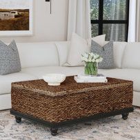 a living room with white couches and pillows on the floor next to a coffee table