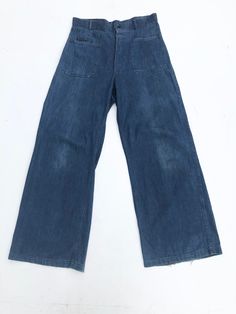 1940s USN denim uniform wide leg trousers have a button front fly, patch hip pockets, and patch back pockets one of which buttons. The stamp on the inside is visible on the right front hip, there's also a name on the inside waist Condition Overall very good with general wear. Has fray along the hems. Has a small light stain above the back right pocket and some fade on the front legs. Measurements Waist 32" Hip 39" Rise 14" Inseam 31" Length 44" Pre-washed Denim Blue Wide Leg Bottoms, Pre-washed Wide Leg Denim Bottoms, Retro Flare Jeans For Workwear, Retro Wide-leg Bottoms With Patch Pockets, Vintage High Waist Denim Cargo Jeans, Retro Wide-leg Denim Cargo Jeans, Retro Wide Leg Pants With Patch Pockets, Vintage High-waist Denim Cargo Jeans, Retro Wide Leg Bottoms With Patch Pockets