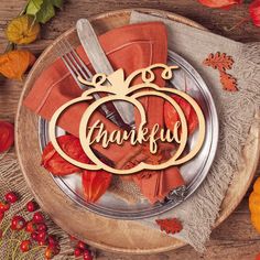 a plate topped with a wooden cutout of a pumpkin