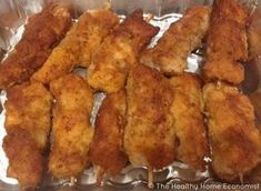 chicken skewers sitting on top of foil in a pan