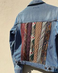 a denim jacket with different colored ties on it