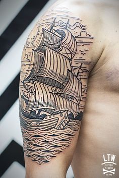 a man with a ship tattoo on his arm