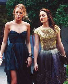 two women walking down the street with one wearing a dress and the other in a gown