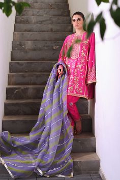 Channeling the old world charm of a kalidar kurta paired with shalwar, Serina is a striking hot pink number cut from pure rawsilk. The undulating trail of the geometric lime green and lavender contrasting organza dupatta hones in the ethereal aura. Model height: 5'3 Length: 38" Cut: relaxed fit In this price range, the Green And Lavender, Organza Shirt, Organza Dupatta, Silk Dupatta, Price Range, Silk Organza, Old World Charm, Raw Silk, Model Height