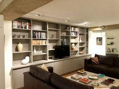 a living room filled with furniture and bookshelves