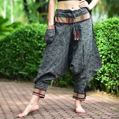 "Black Thai Traditional pattern pants, Hmong pants, Traditional Thai pants, Harem pants, Unisex pants Tribal pants is very comfortable and easy to wear, Unisex for Men and Women Every Detail of Tribal pants is made by Thai Craftsmanship. Tribal pants is inspired by Tribal in the North of Thailand or Hmong. Redesign for easy to wear and comfy. Great for many occasion activities like Chilling time, Casual wear, Relax time. This item is made of high-quality cotton in the north of Thailand. Printed Black Bohemian Ankle-length Pants, Traditional Trousers For Festival, Traditional Festival Trousers, Black Harem Pants For Festival, Traditional Black Wide Leg Bottoms, Traditional Long Pants Bottoms With Pockets, Traditional Bottoms With Pockets In Long Pants Style, Traditional Black Harem Pants, Traditional Style Harem Pants For Festivals