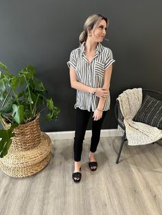 This striped short sleeve button down top features rolled cuffs and a front chest pocket. This top is on trend is perfect paired with a pair of black denim shorts! fits true to size. 100% Rayon Casual Shirt With Vertical Stripes And Shirttail Hem, Casual Summer Shirt With Striped Collar, Vertical Stripes Shirt For Summer Day Out, Summer Shirt With Vertical Stripes For Day Out, Summer Day Out Shirt With Vertical Stripes, Casual Tops With Vertical Stripes And Shirttail Hem, Casual Striped Tops With Roll-up Sleeves, Spring Striped Short Sleeve Shirt With Relaxed Fit, Trendy Striped Shirt For Day Out