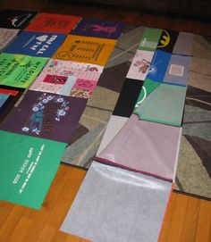 several pieces of cloth laid out on the floor with different colors and designs in them