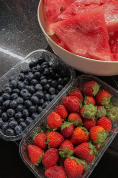 two plastic containers filled with watermelon, blueberries and strawberries next to each other