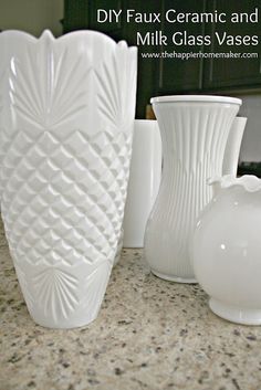 several white vases sitting on top of a counter