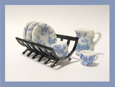 a set of blue and white dishes sitting next to each other