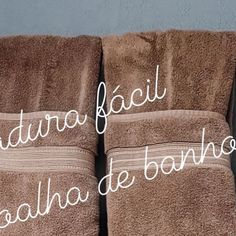 three brown towels with white writing on them