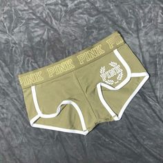 Olive Green With White Trim Pink Crest Logo On Front Left Soft Cotton Low Rise Curved Hem Binding At Leg Pink Logo Waistband Imported Cotton/Spandex Trendy Short Boxer Briefs For Loungewear, Stretch Short Boxer Briefs With Letter Print, Stretch Boxer Briefs With Letter Print, Casual Short Boxer Briefs With Letter Print, Green Cotton Boxer Briefs, Stretch Letter Print Boxer Briefs For Loungewear, Summer Letter Print Short Boxer Briefs, Sporty Green Cotton Boxer Briefs, Green Cotton Shorts With Letter Print