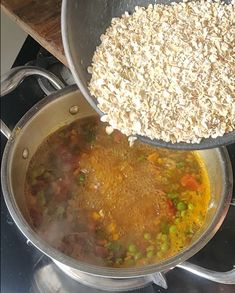 a pot filled with food sitting on top of a stove next to a pan full of oatmeal