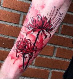 a person with a red flower tattoo on their arm