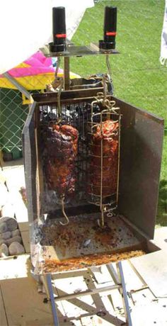 two meats are cooking on an outdoor grill