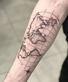 a man's arm with a world map tattoo on the left side of his arm