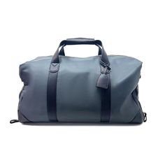 a gray duffel bag with black handles and straps on the handle, sitting against a white background