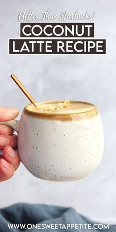 a hand holding a bowl of coconut latte