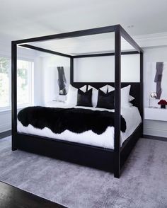 an open book showing a black and white photo of a bedroom with four poster bed