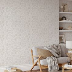 a living room with a white couch and wooden coffee table in front of the wall