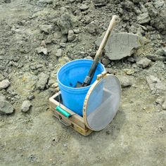 a bucket and shovel sitting on the ground