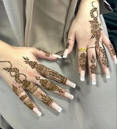 two women with henna tattoos on their hands