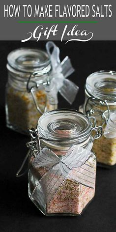 three glass jars filled with different types of salt and seasoning next to each other