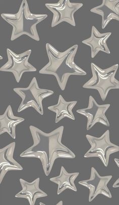 silver stars on a gray background are shown in this image, and it looks like they have been made out of aluminum foil