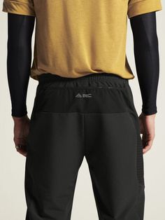 Gear up for any weather with the men's PRO Trail SubZ Pants by Craft Sportswear. Made with a wind and water-resistant stretch fabric, these warm running pants ensure optimal comfort during your cold runs. It offers a regular fit that accommodates your long underwear on extra chilly days. A convenient leg pocket at the right side, concealed front zip pockets, and three mesh compartments at the back make storage easy. Also features an adjustable drawcord at the waist and zippered elastic leg endin Technical 4-way Stretch Black Bottoms, Black Running Pants With Elastic Waistband, Technical Black Bottoms For Outdoor, Techwear Sports Bottoms With Moisture-wicking, Running Sportswear Bottoms In Technical Fabric, Moisture-wicking Techwear Bottoms For Sports, Sporty Hiking Bottoms With Functional Pockets, Black Functional Joggers With Pockets, Moisture-wicking Sports Techwear Bottoms