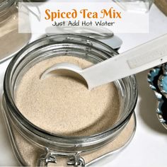 spiced tea mix in a glass jar with a spoon