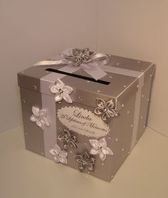 a silver and white box with flowers on it