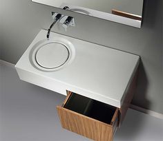 a bathroom sink with an open drawer underneath it