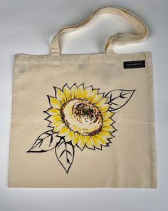 A little bit of summer all year round with this beautiful Sunflower tote.  The bag is made from 100% Organic Cotton and is natural and unbleached. The design is lovingly hand drawn and painted with high quality fabric paints. The dimensions of the bag are as follows:  Height:   38cm Width:   41cm Handle Length:   54cm Handle Width:   2.5cm  PLEASE NOTE: This is hand painted like a work of Art and is not screen printed.  Thanks for looking. Hand Painted Summer Tote Bag, Hand Painted Tote Bag For Summer, Summer Hand Painted Rectangular Bags, Hand Painted Rectangular Summer Bags, Summer Flower-shaped Canvas Bag, Rectangular Hand Painted Bags For Summer, Hand Painted Cotton Tote Canvas Bag, Hand Painted Rectangular Cotton Canvas Bag, Hand Painted Cotton Canvas Bag For Everyday Use