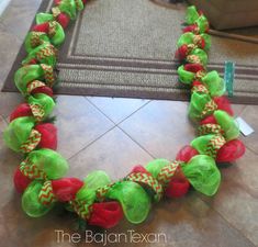 a green and red wreath on the floor