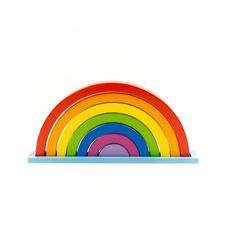 a set of four rainbow plates sitting on top of a blue plate holder with a white background