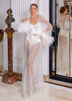 Born to shine! This robe will make you feel like a queen. Luxurious shiny sequined lace embroidered with pearls of different sizes. The sleeves of the robe are decorated with flowers made of natural feathers, which we create by hand according to our design. The robe has a soft mesh lining. The image is complemented by a thin belt, which is also decorated with natural feathers. This piece fits true to our size chart. If you're not sure which size will fit you perfectly, just choose your regular size to place an order. After placing an order, one of our team members will reach out to you by message or email to get all your measurements, height, and the date of your wedding, to create and deliver your perfect robe in time. The bodysuit is not included. All our items are 100% handmade and cust Born To Shine, Bridal Shower Dress, Shower Dresses, Team Members, Bridesmaid Robes, Bridal Robes, Bridal Lingerie, Sample Sale, To Shine