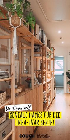 a wooden book shelf filled with lots of books and plants on top of it's shelves