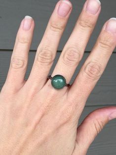 A lovely 12mm emerald green aventurine has been set in sterling silver with a handmade ring band from sterling silver half dome wire. The aventurine stone has a natural inner crystal texture that comes out in different lights but otherwise is a lovely emerald forest green. The sterling silver has been given a dark patina or oxidized finish that gives this ring a little edge and highlights the green aventurine stand out.Made to order!Green aventurine is a comforting stone. It helps calm the heart Everyday Sterling Silver Cabochon Jewelry, Minimalist Everyday Jewelry With Cabochon, Minimalist Everyday Cabochon Jewelry, Everyday Oval Bezel Set Jewelry, Everyday Nickel-free Oval Jewelry, Modern Adjustable Cabochon Jewelry, Adjustable Emerald Ring With Round Band As Gift, Modern Green Oval Cabochon Jewelry, Adjustable Round Band Emerald Ring As Gift